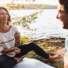 Friends playing cards by a lake