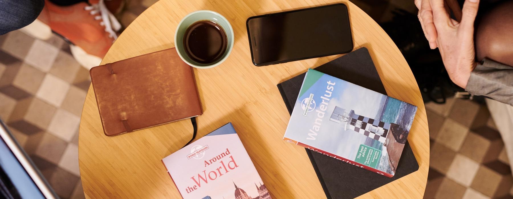 a table with a tablet and a cup of coffee