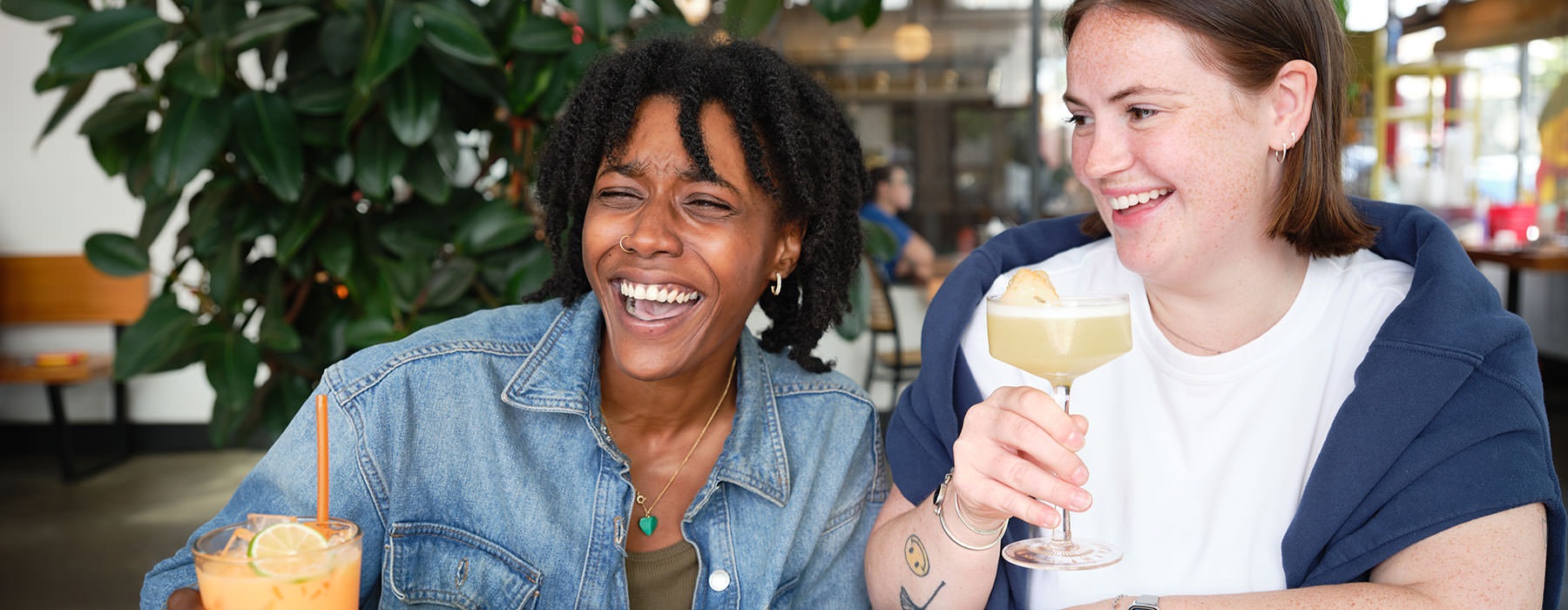 friends smiling sharing a drinl